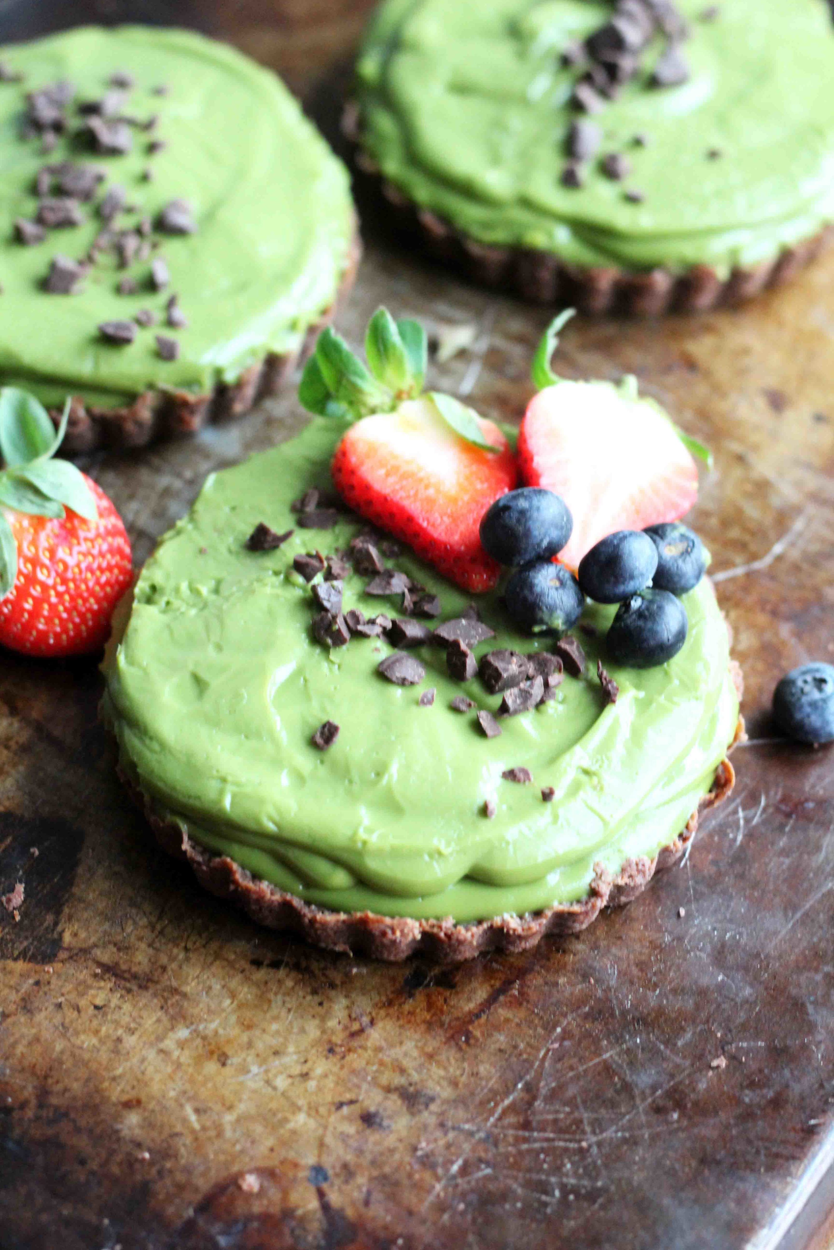 This Matcha Tart is secretly healthy! It's vegan, sweetened with coconut sugar and maple syrup and has a whole wheat chocolate crust.