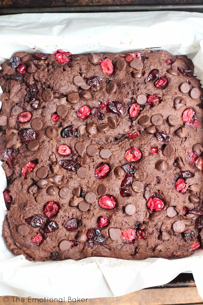 These Vegan Dark Chocolate Brownies are the perfect combo of cake-y and fudge-y. Loaded with fresh cranberries and chocolate, you'll certainly love these sweet bars!
